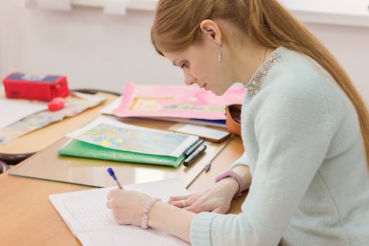 young beautiful woman writing with left hand. photo
