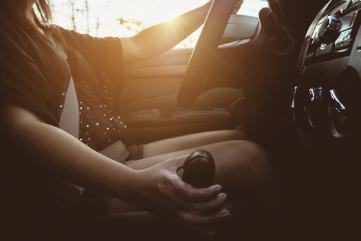 Lady driving car holding automatic gear shift transmission control photo