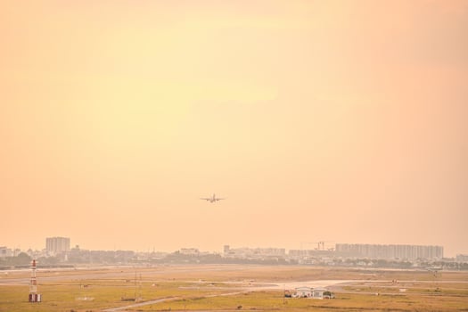 Ho Chi Minh city, Vietnam - FEB 12 2022 Airplane fly over urban areas preparing landing into Tan Son Nhat International Airport and takes off in TSN airport photo