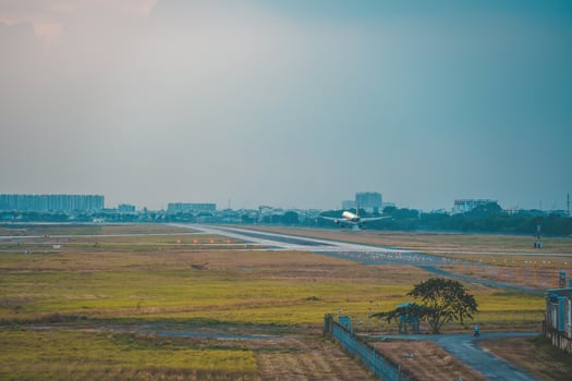Ho Chi Minh city, Vietnam - FEB 12 2022 Airplane fly over urban areas preparing landing into Tan Son Nhat International Airport and takes off in TSN airport photo
