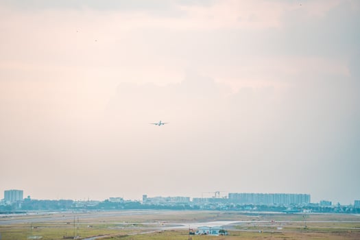 Ho Chi Minh city, Vietnam - FEB 12 2022 Airplane fly over urban areas preparing landing into Tan Son Nhat International Airport and takes off in TSN airport photo