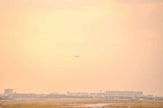 Ho Chi Minh city, Vietnam - FEB 12 2022 Airplane fly over urban areas preparing landing into Tan Son Nhat International Airport and takes off in TSN airport photo