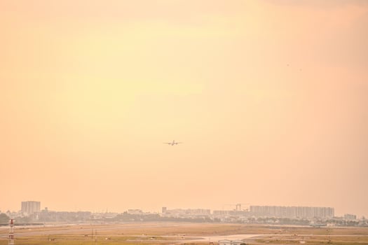 Ho Chi Minh city, Vietnam - FEB 12 2022 Airplane fly over urban areas preparing landing into Tan Son Nhat International Airport and takes off in TSN airport photo