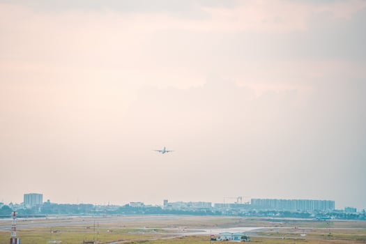 Ho Chi Minh city, Vietnam - FEB 12 2022 Airplane fly over urban areas preparing landing into Tan Son Nhat International Airport and takes off in TSN airport photo