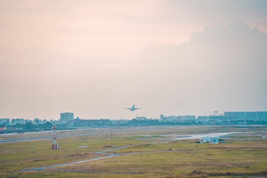 Ho Chi Minh city, Vietnam - FEB 12 2022 Airplane fly over urban areas preparing landing into Tan Son Nhat International Airport and takes off in TSN airport photo