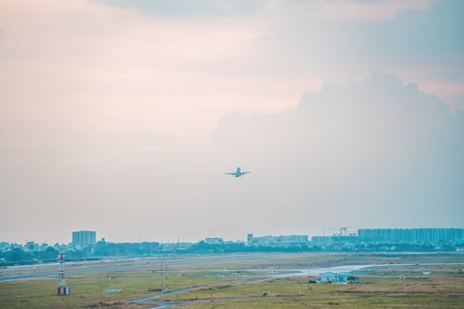 Ho Chi Minh city, Vietnam - FEB 12 2022 Airplane fly over urban areas preparing landing into Tan Son Nhat International Airport and takes off in TSN airport photo