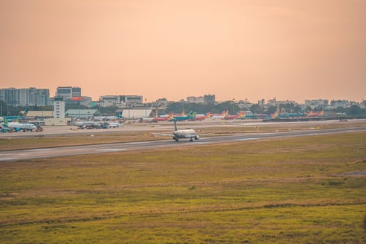 Ho Chi Minh city, Vietnam - FEB 12 2022 Airplane fly over urban areas preparing landing into Tan Son Nhat International Airport and takes off in TSN airport photo