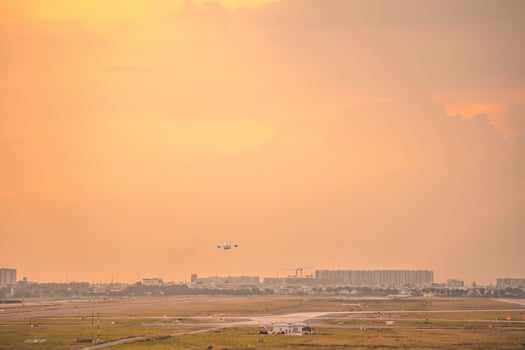 Ho Chi Minh city, Vietnam - FEB 12 2022 Airplane fly over urban areas preparing landing into Tan Son Nhat International Airport and takes off in TSN airport photo