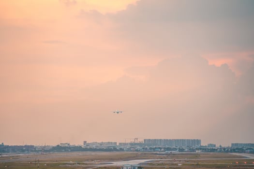Ho Chi Minh city, Vietnam - FEB 12 2022 Airplane fly over urban areas preparing landing into Tan Son Nhat International Airport and takes off in TSN airport photo