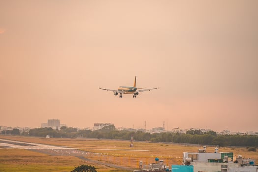 Ho Chi Minh city, Vietnam - FEB 12 2022 Airplane fly over urban areas preparing landing into Tan Son Nhat International Airport and takes off in TSN airport photo