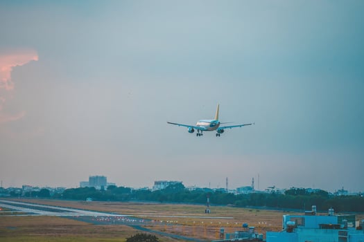 Ho Chi Minh city, Vietnam - FEB 12 2022 Airplane fly over urban areas preparing landing into Tan Son Nhat International Airport and takes off in TSN airport photo