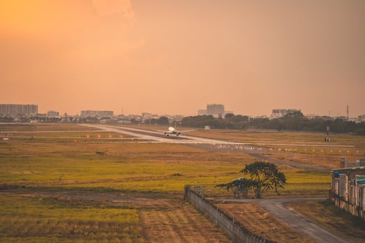 Ho Chi Minh city, Vietnam - FEB 12 2022 Airplane fly over urban areas preparing landing into Tan Son Nhat International Airport and takes off in TSN airport photo