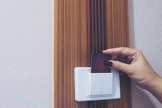 Lady putting key card switch in hotel room photo