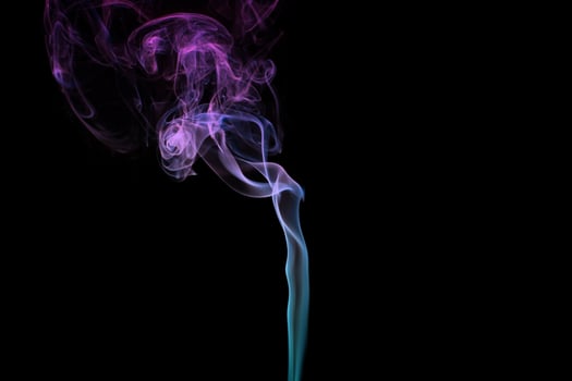 Multicolored smoke for aromatherapy relaxation on black background, beautiful swirled puffs of smoke photo