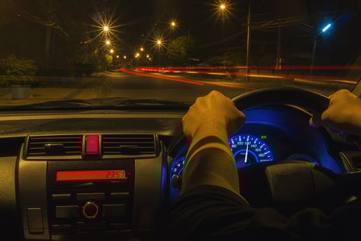 Man driving car in a night time, left-driving countries photo