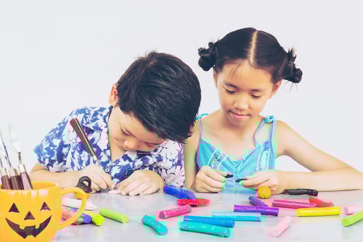 Boy and girl are happily playing clay toy photo