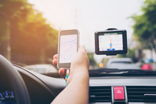 Man driving car using navigator and looking map on mobile phone photo