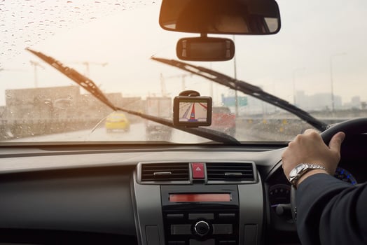 Business man is driving a car in raining day with moving wiper blades photo