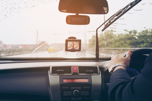 Business man is driving a car in raining day with moving wiper blades photo