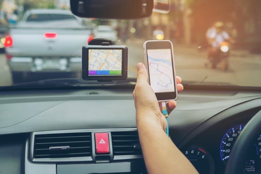 Man driving car using navigator and looking map on mobile phone photo