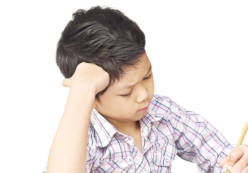 A boy is unhappy doing homework photo