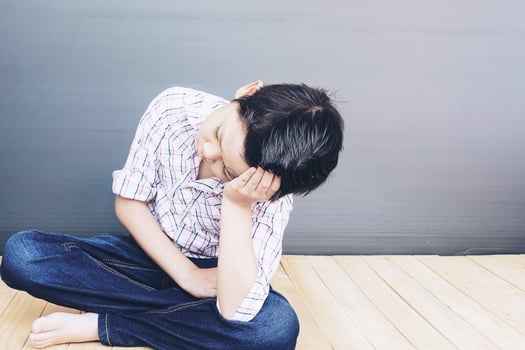 7 years old Asian boy is feeling sad photo