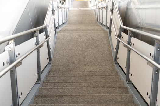 public staircase at station or mall for exit, entrance. stair inside the metro subway with cleanly steel handrail. An empty staircase at a metro station photo