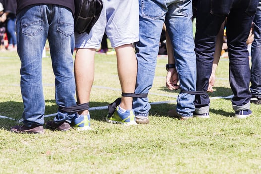 Five legged race outdoor party game, harmonious unity concept photo