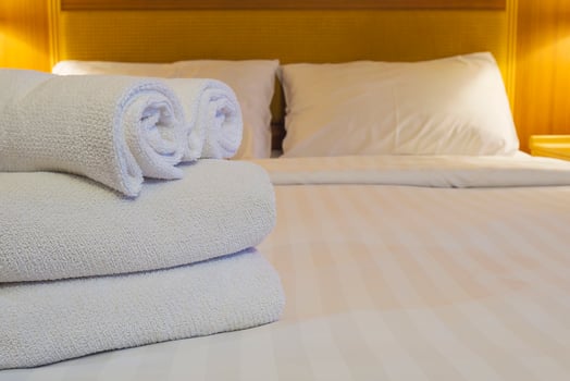 White bedding and towel set in modern hotel photo