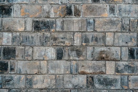 Background of old vintage black and gray dirty brick wall texture photo