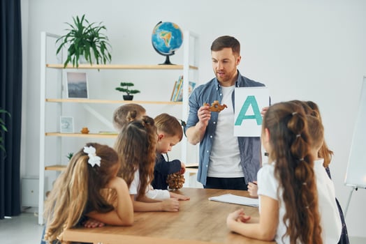 Learn new A letter. Group of children students in class at school with teacher photo