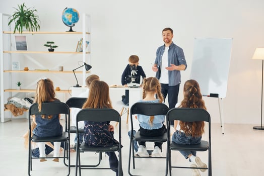 Group of children students in class at school with teacher photo