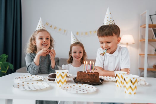 Celebrating brithday. Group of children is together at home at daytime photo