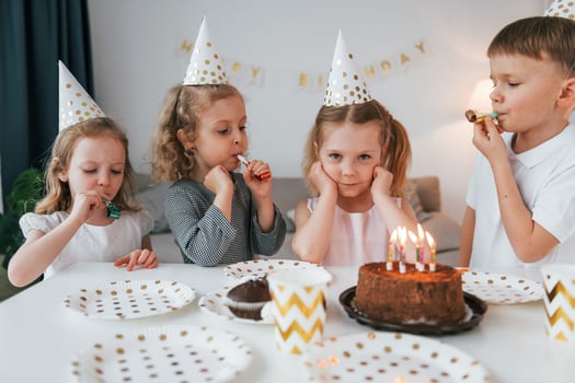 Sweet cake is on the table. Celebrating brithday. Group of children is together at home at daytime photo