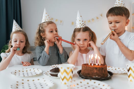 Sweet cake is on the table. Celebrating brithday. Group of children is together at home at daytime photo