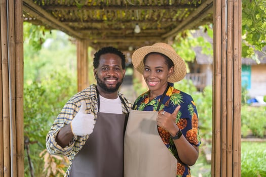 Happy black agronomist couple enjoying and working in farmland, agriculture concept photo
