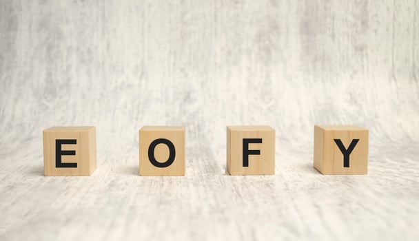EOFY, End of Financial Year text. wood cubes and white background photo