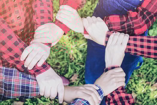People group join hands together as teamwork unity symbol during their meeting activity to achieve their ultimate goal. Vintage tone close up at join hands over blur soft light green garden background photo