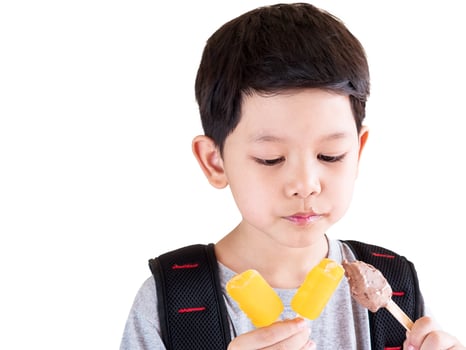 Boy eating ice cream isolated over white background photo
