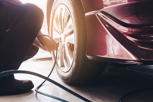 Technician is inflate car tire - car maintenance service transportation safety concept photo