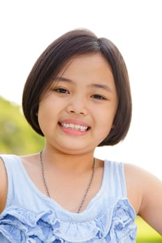 Asian little girl smiling happily in the park photo