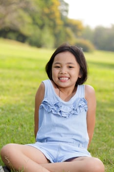 Asian little girl smiling happily in the park photo