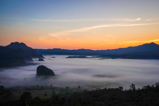 sunrise with fog sea below the mountain. photo