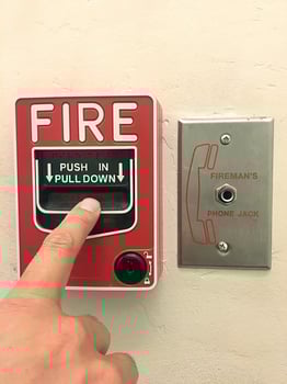 Closeup Shot of button switch fire,Fire alarm box on cement wall for warning and security system. photo