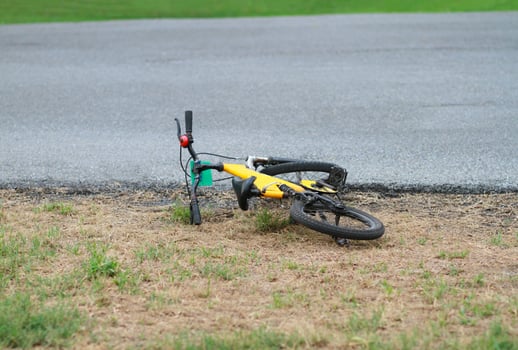 Yellow bike fell off beside the street photo