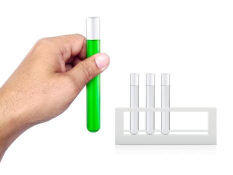 chemical test tube in hand on white isolated background photo