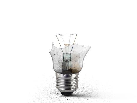 Broken old light bulb isolated on white background photo