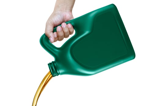 Engine oil pouring from a canister in hand isolated on white background photo