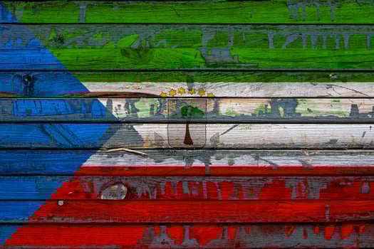 The national flag of Equatorial Guinea is painted on uneven boards. Country symbol. photo