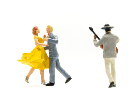 Miniature people Couple dancing with a guitarist playing the guitar photo